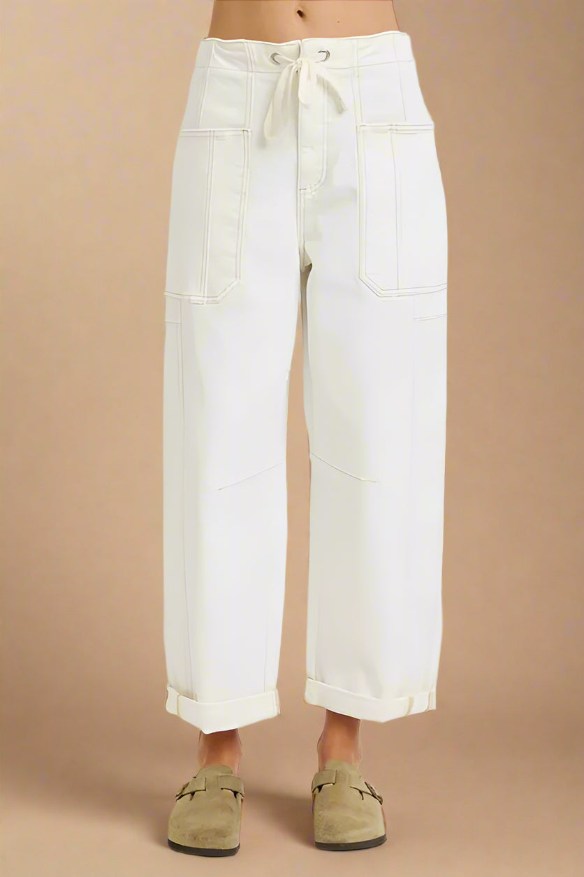 White wide-leg pants worn by a person on a beige background