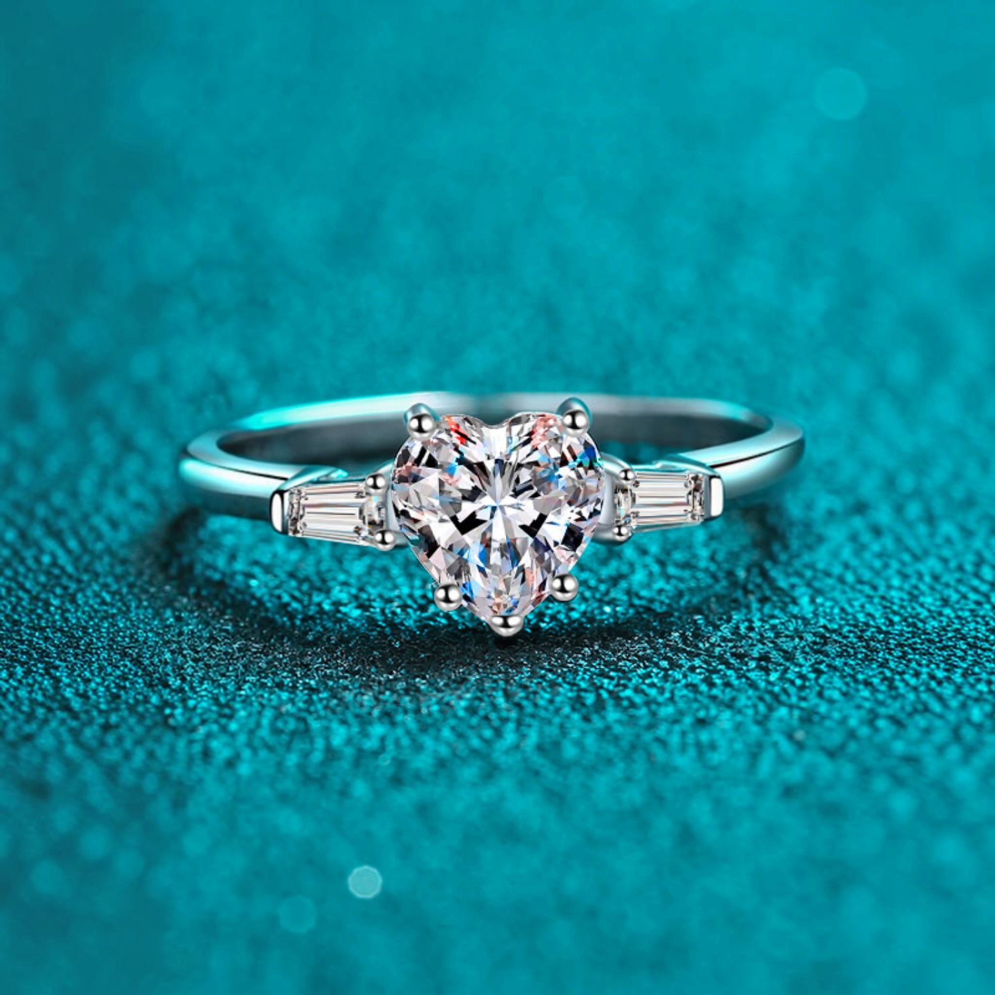 Beach Rose Co. sterling silver ring featuring a heart-shaped moissanite center stone and baguette side stones.