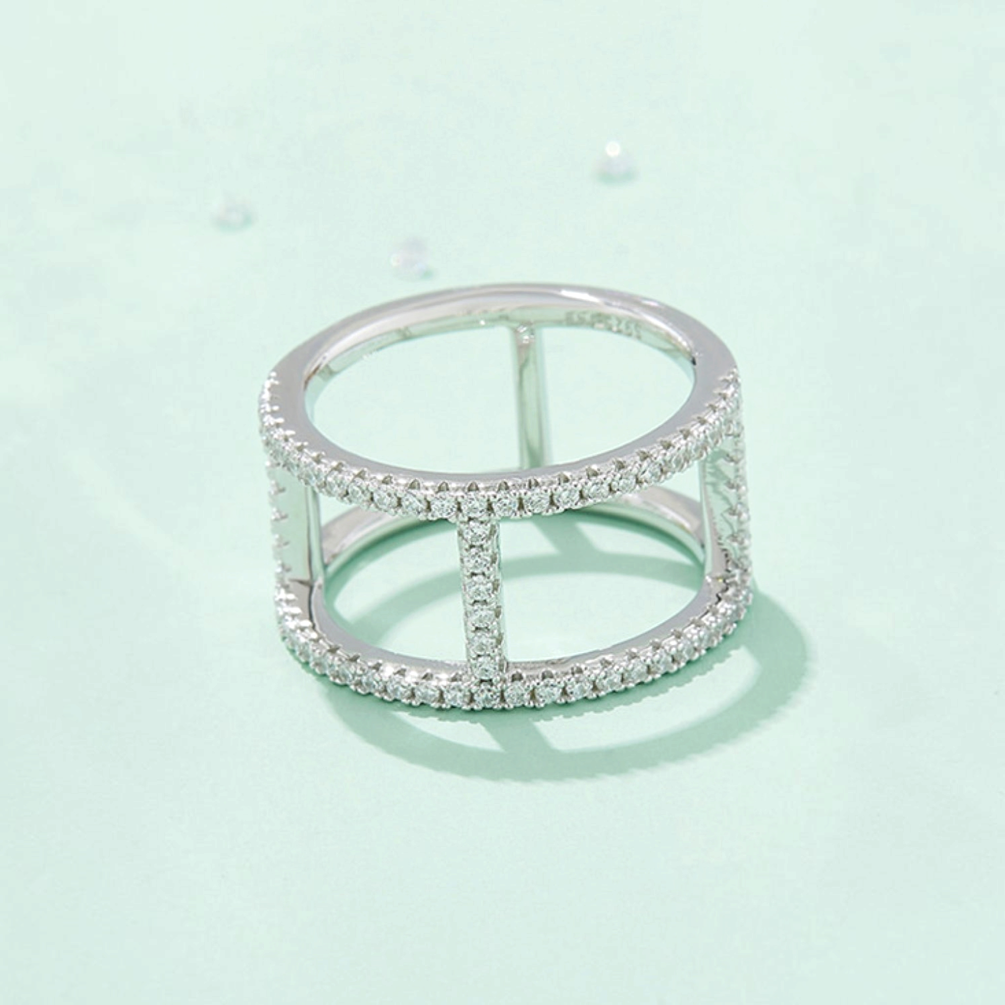 Beach Rose Co. sterling silver openwork ring with sparkling moissanite stones and a polished platinum-plated finish.