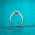 Beach Rose Co. sterling silver three-stone ring with a heart-shaped moissanite center and baguette side stones.