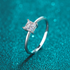 Beach Rose Co. square moissanite solitaire ring in polished rhodium-plated sterling silver with a four-prong setting.