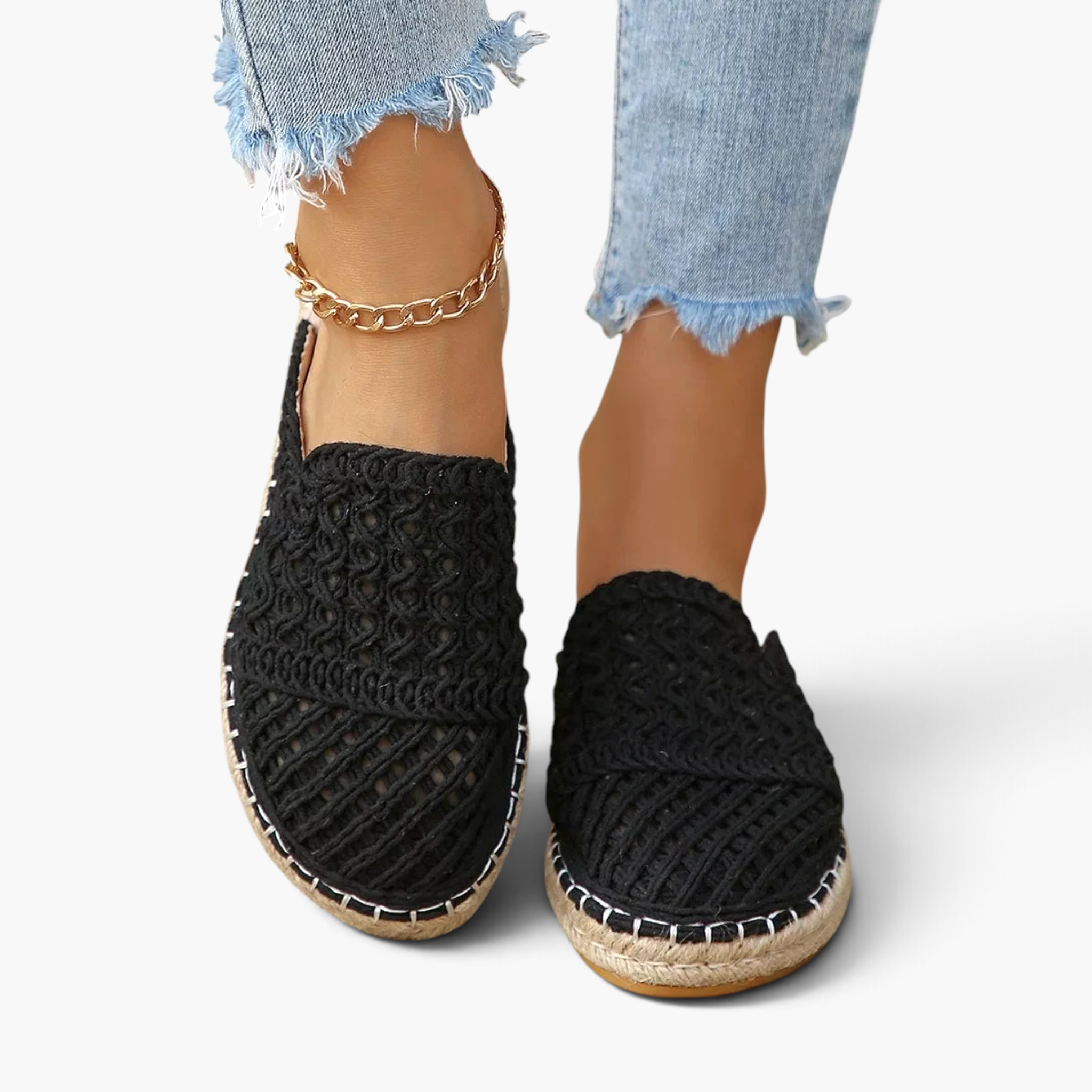 Beach Rose Co. black crochet-style mesh espadrille mules with braided sole trim worn with cropped jeans.