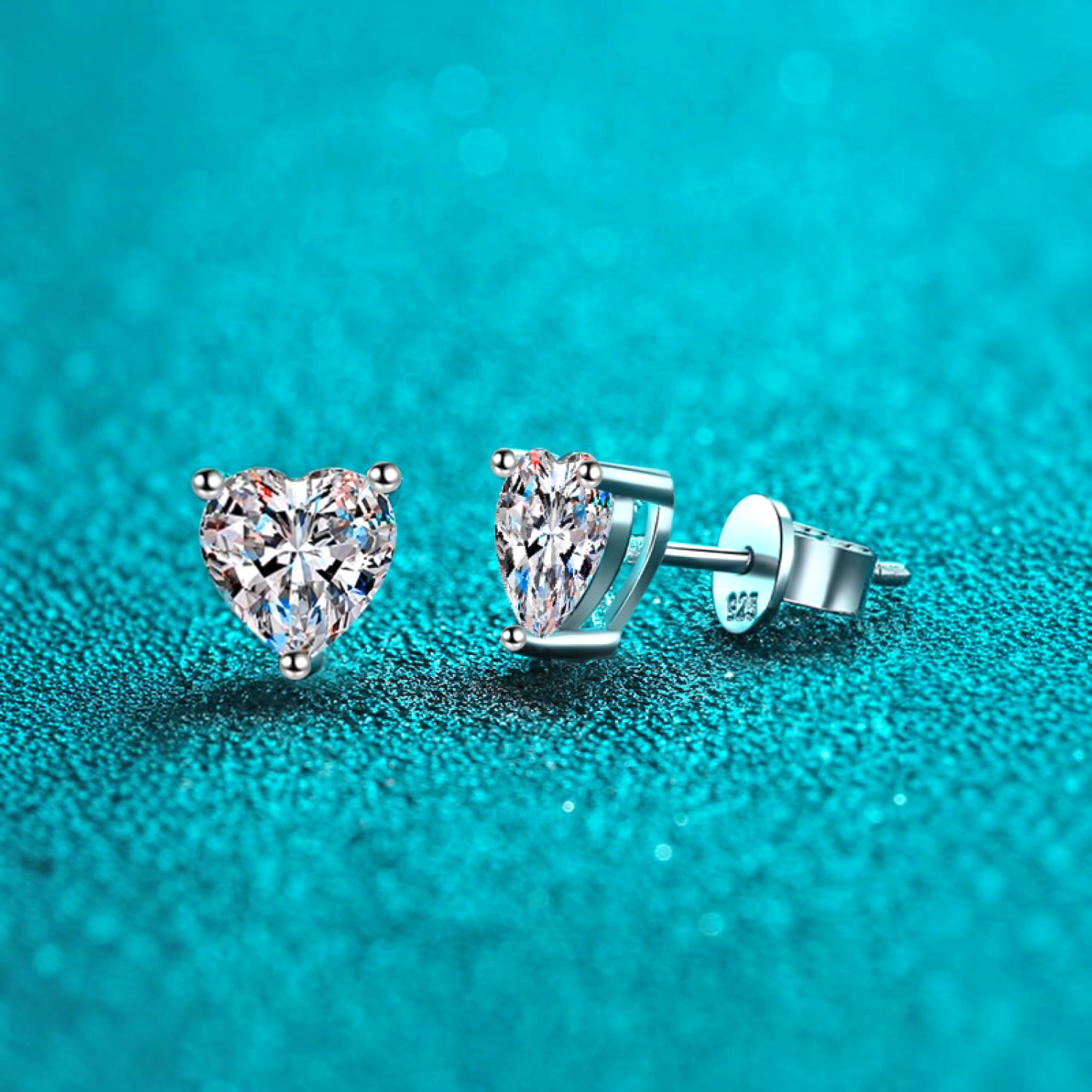 Beach Rose Co. heart-shaped moissanite stud earrings in rhodium-plated sterling silver with three-prong settings.
