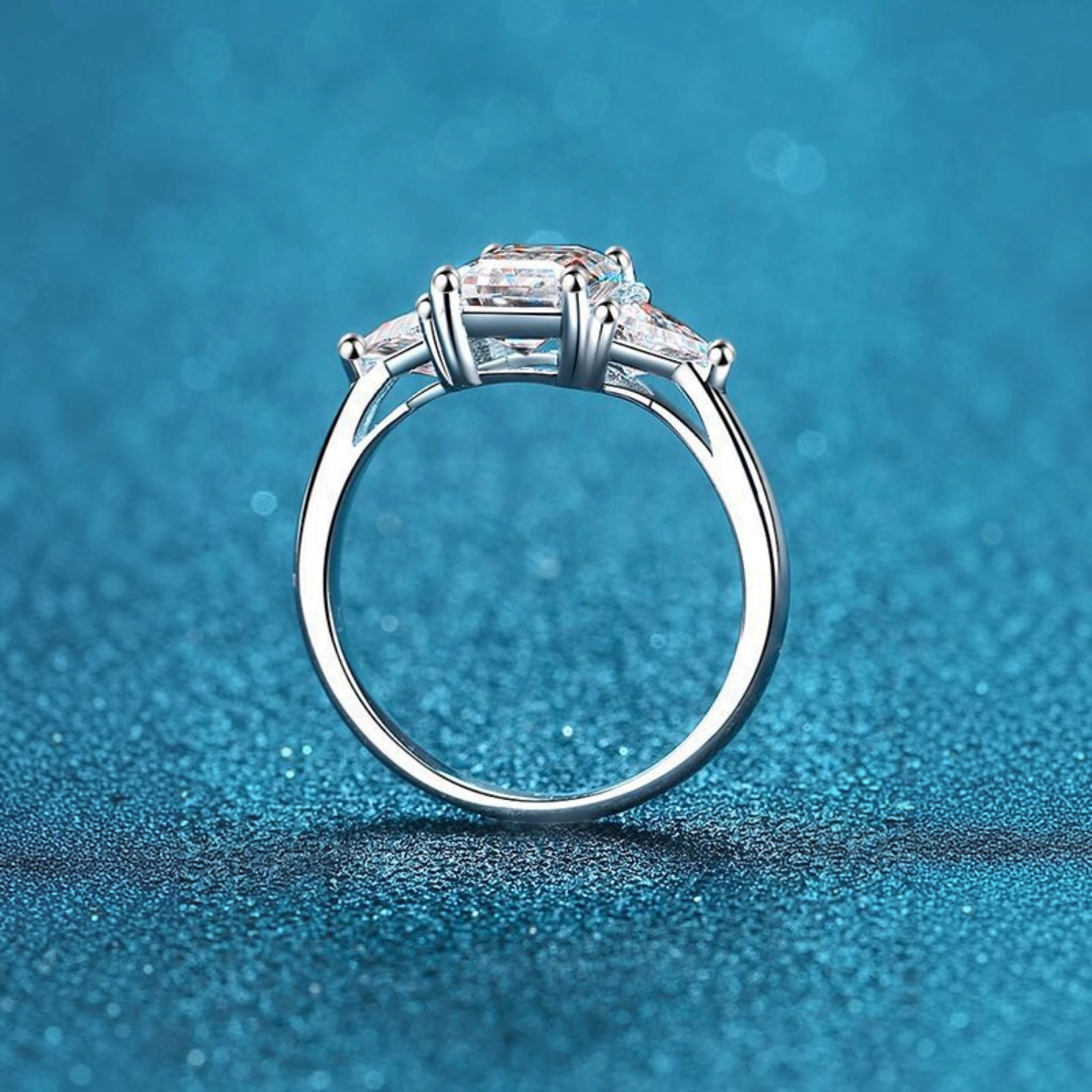 Beach Rose Co. 3-carat moissanite three-stone ring in rhodium-plated sterling silver with square and triangular cuts.