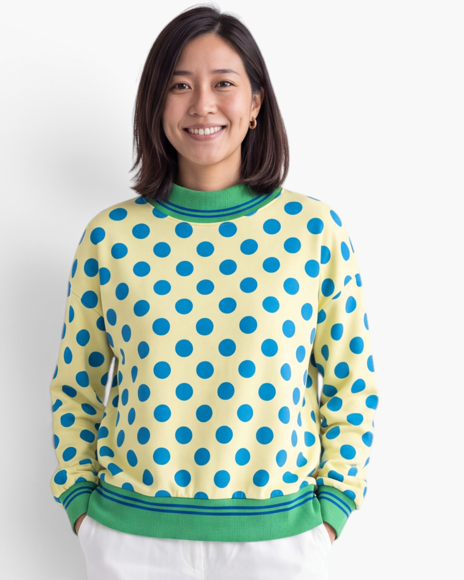 Beach Rose Co. yellow polyester sweatshirt with blue polka dots and green striped trim on a smiling woman.