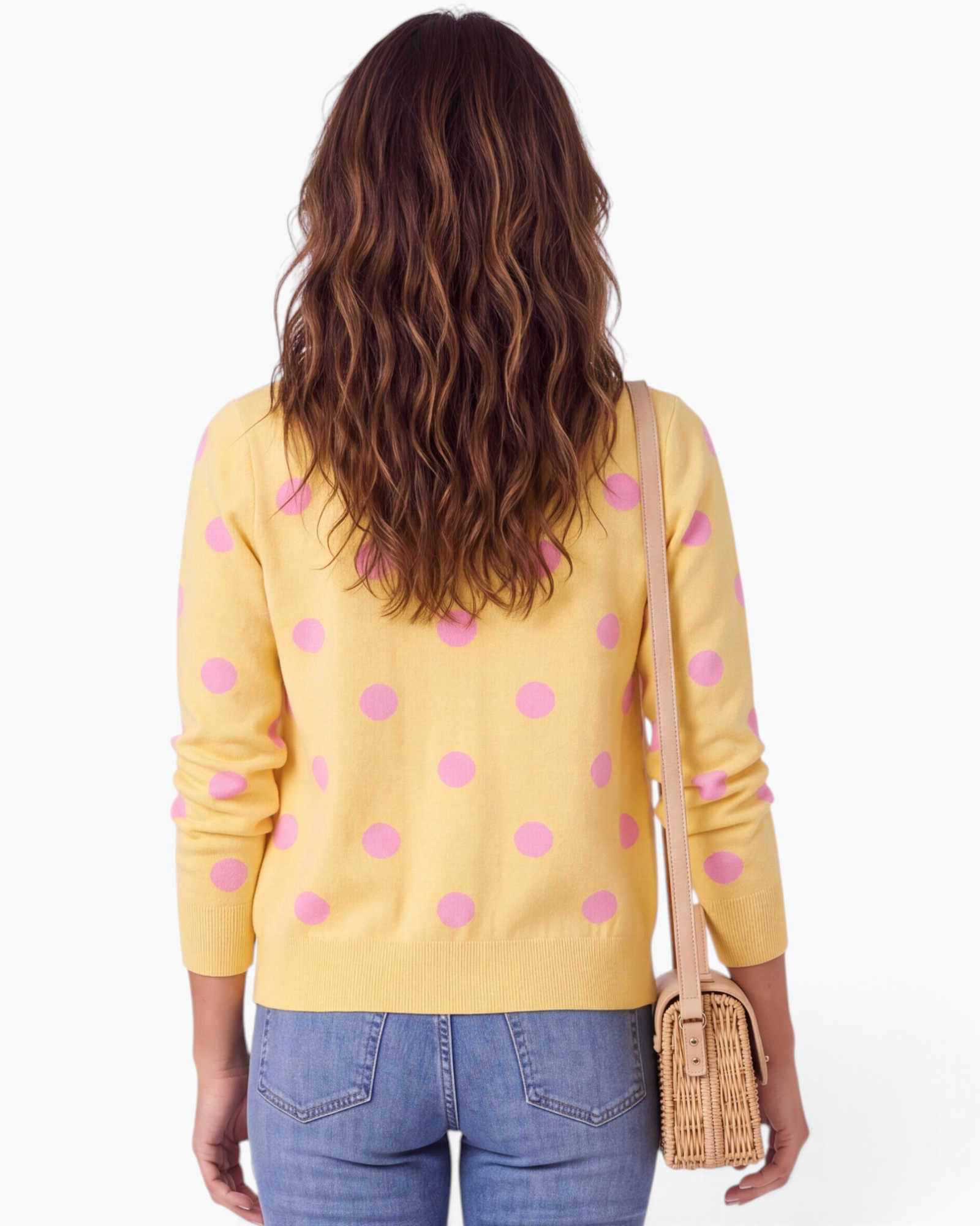 Beach Rose Co. yellow knit cardigan with pink polka dots, long sleeves, and ribbed hem, worn from the back.