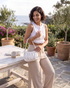Beach Rose Co. cream ribbed wide-leg pull-on pants with elastic waistband and side pockets worn outdoors.