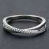 Beach Rose Co. sterling silver crisscross ring featuring a delicate row of sparkling moissanite stones.