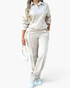 Beach Rose Co. cream two-piece set with a collared pullover and wide-leg pants featuring raised front seam details.