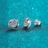 Beach Rose Co. sterling silver stud earrings featuring round moissanite stones in a polished swirl setting.