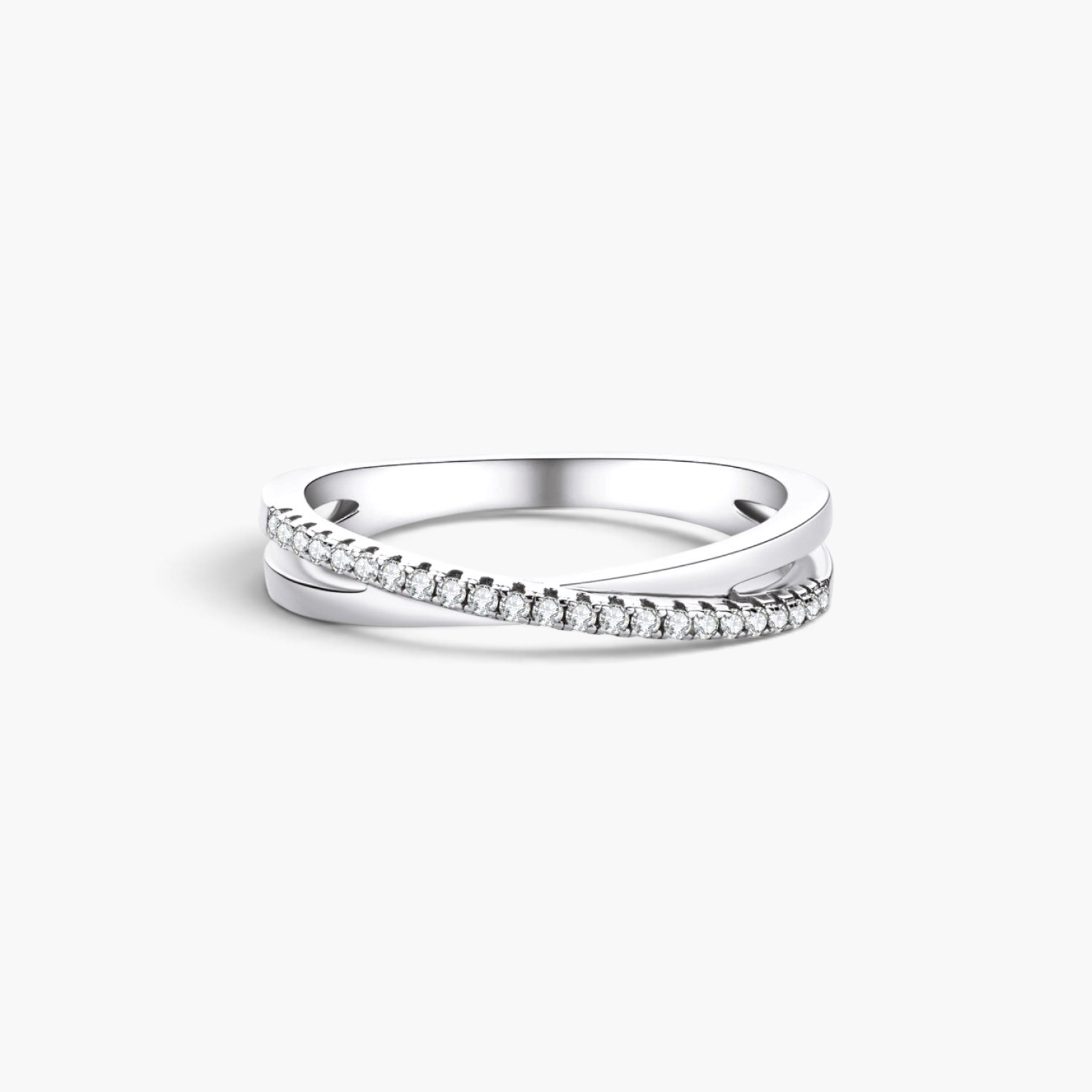 Beach Rose Co. sterling silver crisscross ring featuring a delicate band with sparkling moissanite stones.