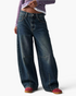 Beach Rose Co. relaxed barrel-leg jeans in faded blue denim with knee darts and seamed detailing.