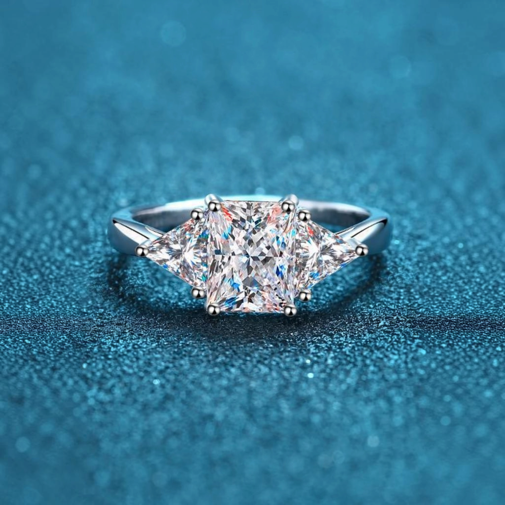 Beach Rose Co. 3 carat moissanite three-stone ring in rhodium-plated sterling silver with square and triangular cuts.