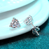 Beach Rose Co. heart-shaped moissanite stud earrings in rhodium-plated sterling silver with three-prong settings.