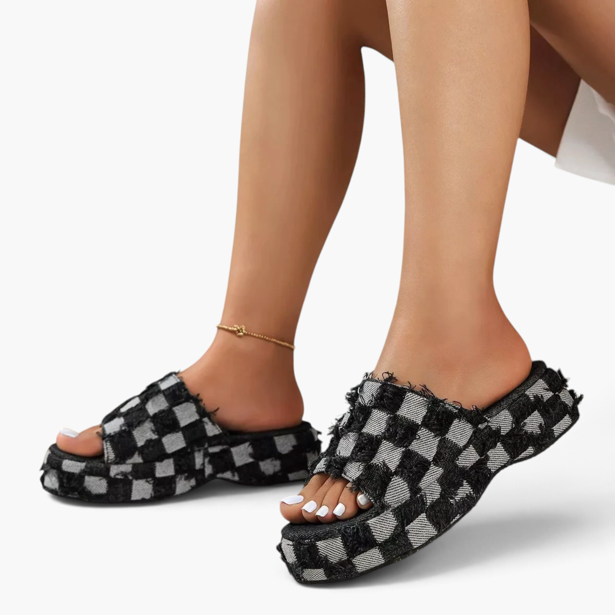 Beach Rose Co. black and white checkered frayed denim platform slides worn on feet with an open toe slip-on design.