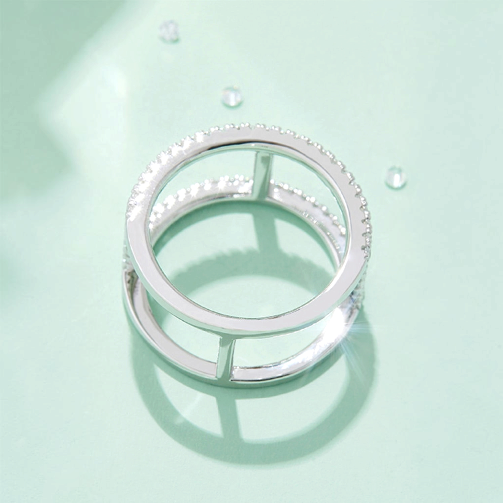 Beach Rose Co. sterling silver openwork ring with moissanite stones and a polished platinum-plated finish.