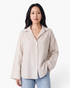 Beach Rose Co. beige and white striped button-up shirt with a relaxed fit, collared neckline, and wide long sleeves.