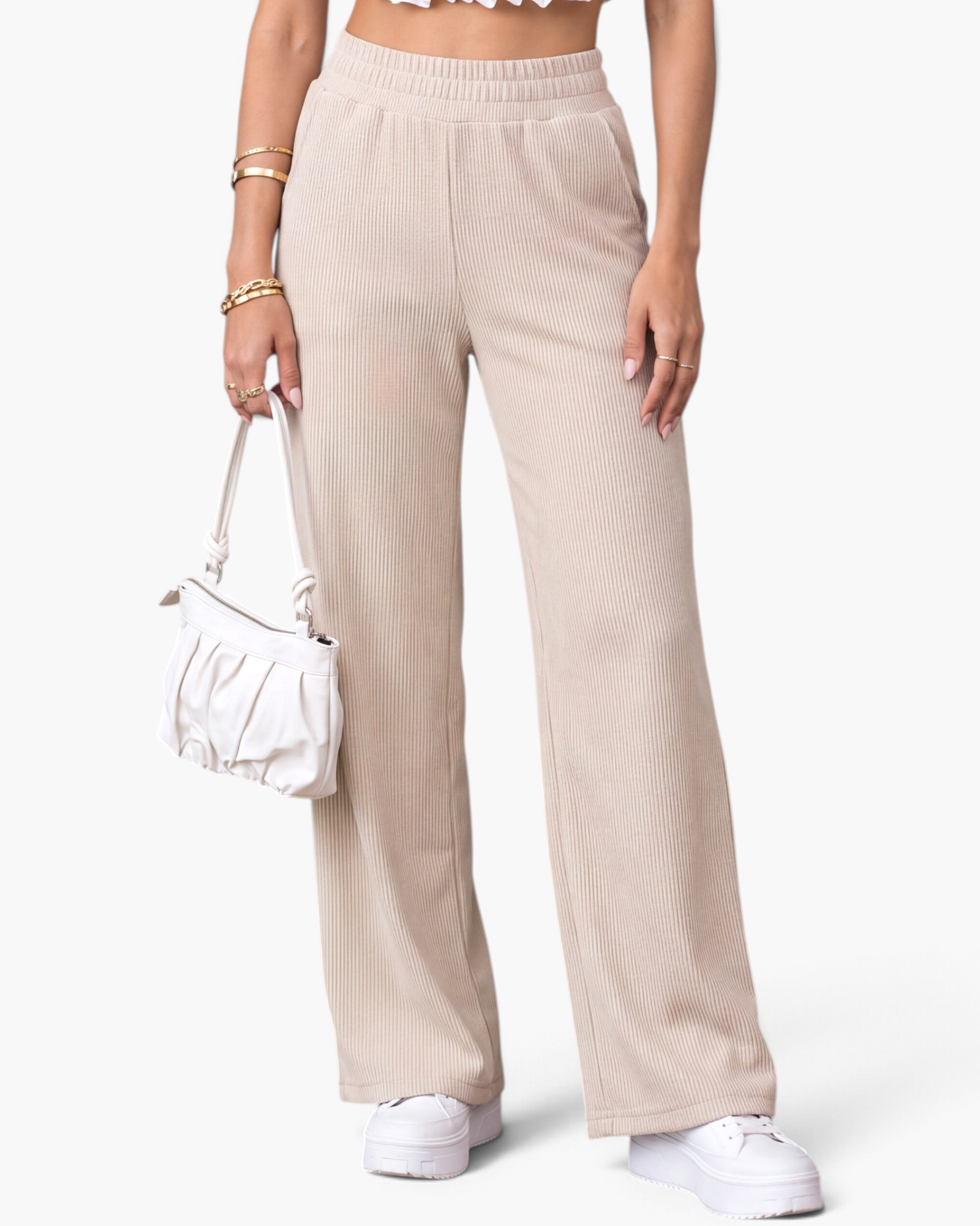 Beach Rose Co. cream ribbed wide-leg pants with an elastic waistband and side pockets on a model.