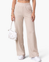 Beach Rose Co. cream ribbed wide-leg pants with an elastic waistband and side pockets on a model.