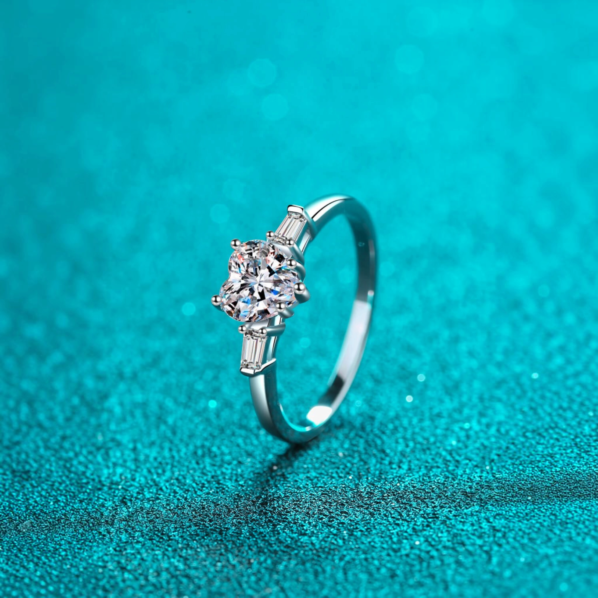 Beach Rose Co. sterling silver ring featuring a heart-shaped moissanite center stone and baguette side stones.