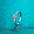 Beach Rose Co. sterling silver ring featuring a heart-shaped moissanite center stone and baguette side stones.