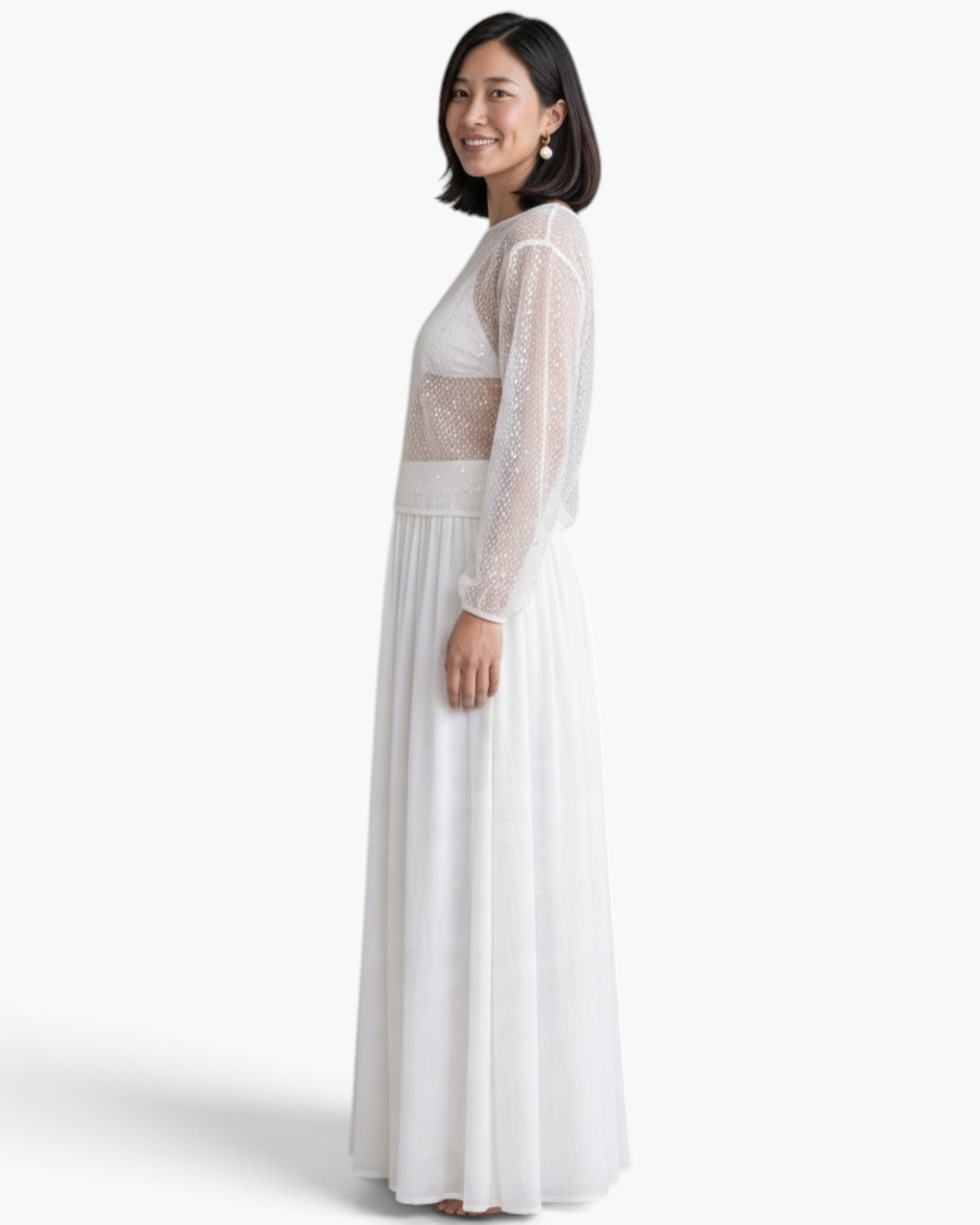 Beach Rose Co. white sheer mesh top with scattered sequins and long balloon sleeves worn with a matching maxi skirt.