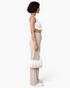 Beach Rose Co. cream ribbed wide-leg pull-on pants with an elastic waistband and side pockets, side profile view.