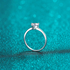 Beach Rose Co. sterling silver ring with a heart-shaped moissanite solitaire on a slim rhodium-plated band.