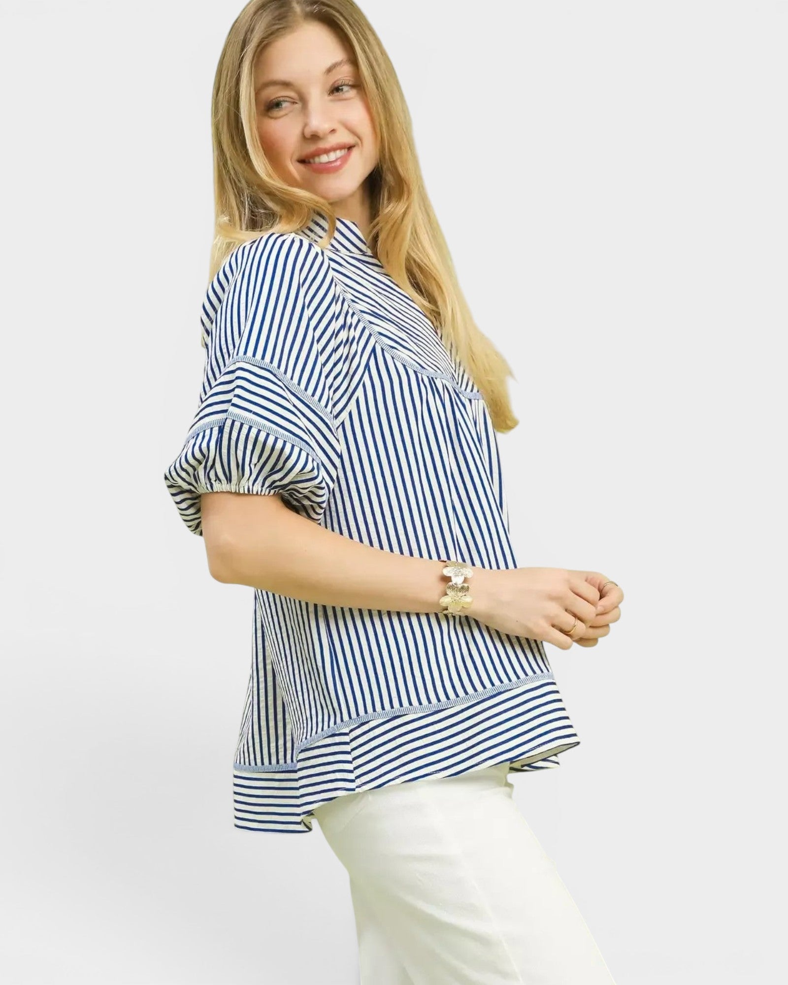 Woman wearing a blue and white striped shirt on a plain background