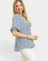 Woman wearing a blue and white striped shirt on a plain background
