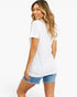 A woman modeling a white short-sleeve t-shirt from the back, paired with denim shorts, against a plain white studio background.