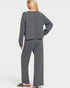 Person wearing a gray lounge set on a white background